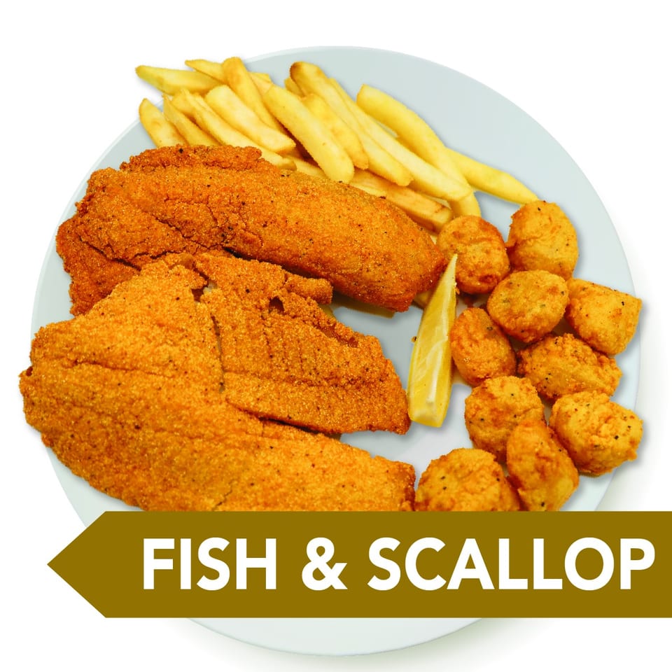 Fried fish fillets, scallops, french fries, and a lemon wedge on a white plate.