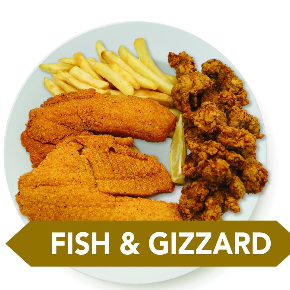 Fried fish fillets, crispy gizzards, french fries, and a lemon wedge on a white plate.